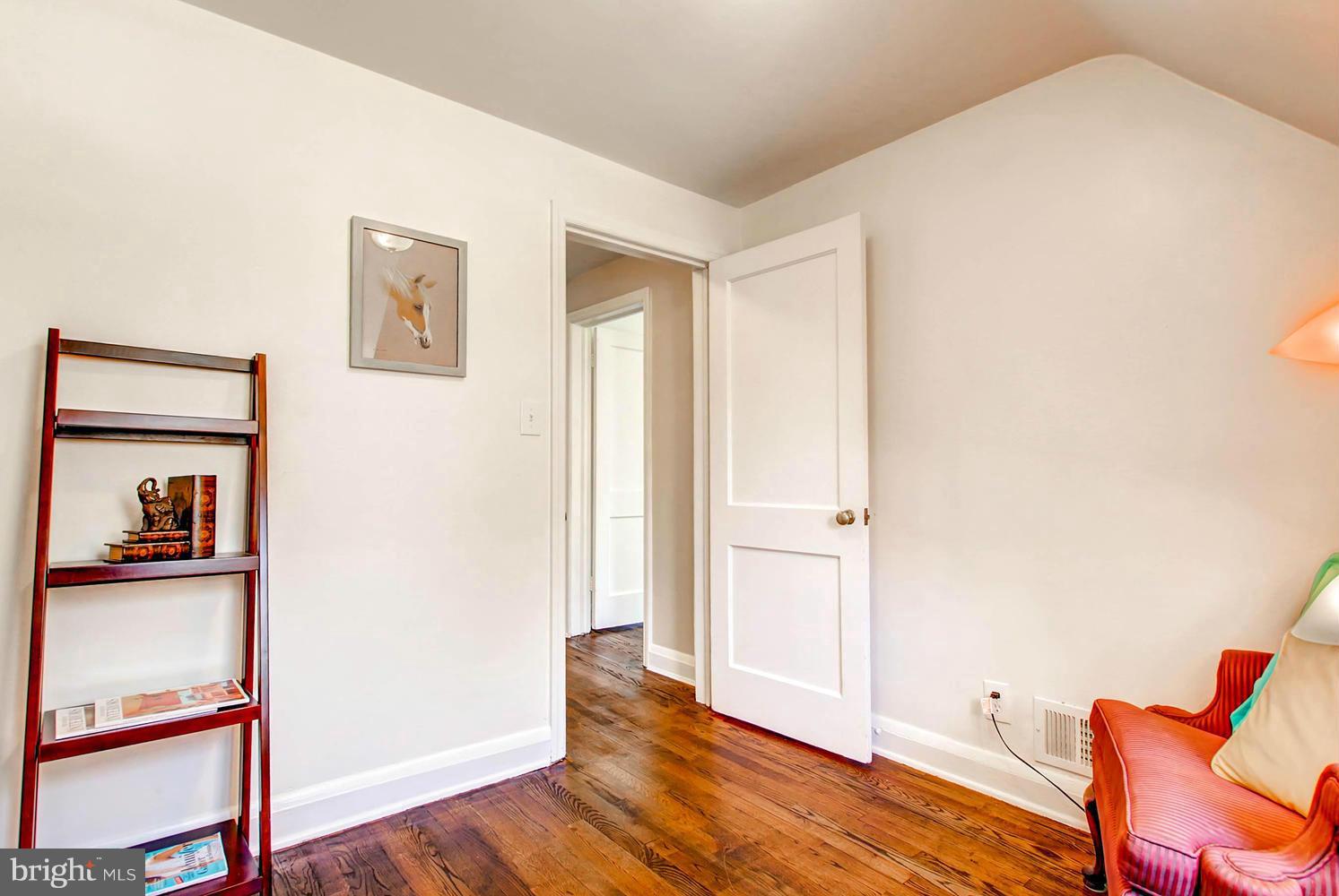 609 Cylburn Road Baltimore, MD 21208 - Photo 18 of 30 a view of room with hardwood floor and hallway
