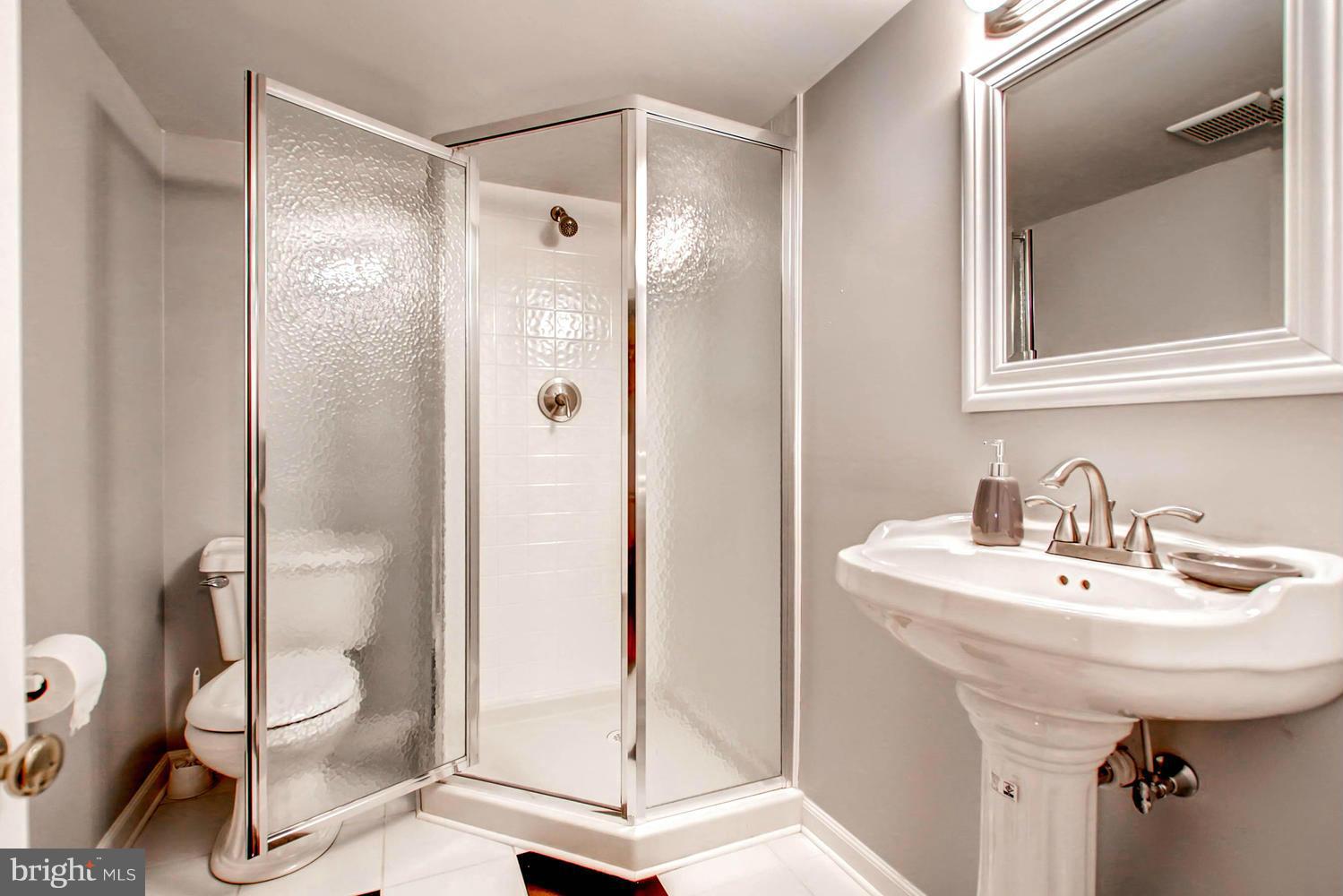 609 Cylburn Road Baltimore, MD 21208 - Photo 20 of 30 a bathroom with a sink toilet and shower