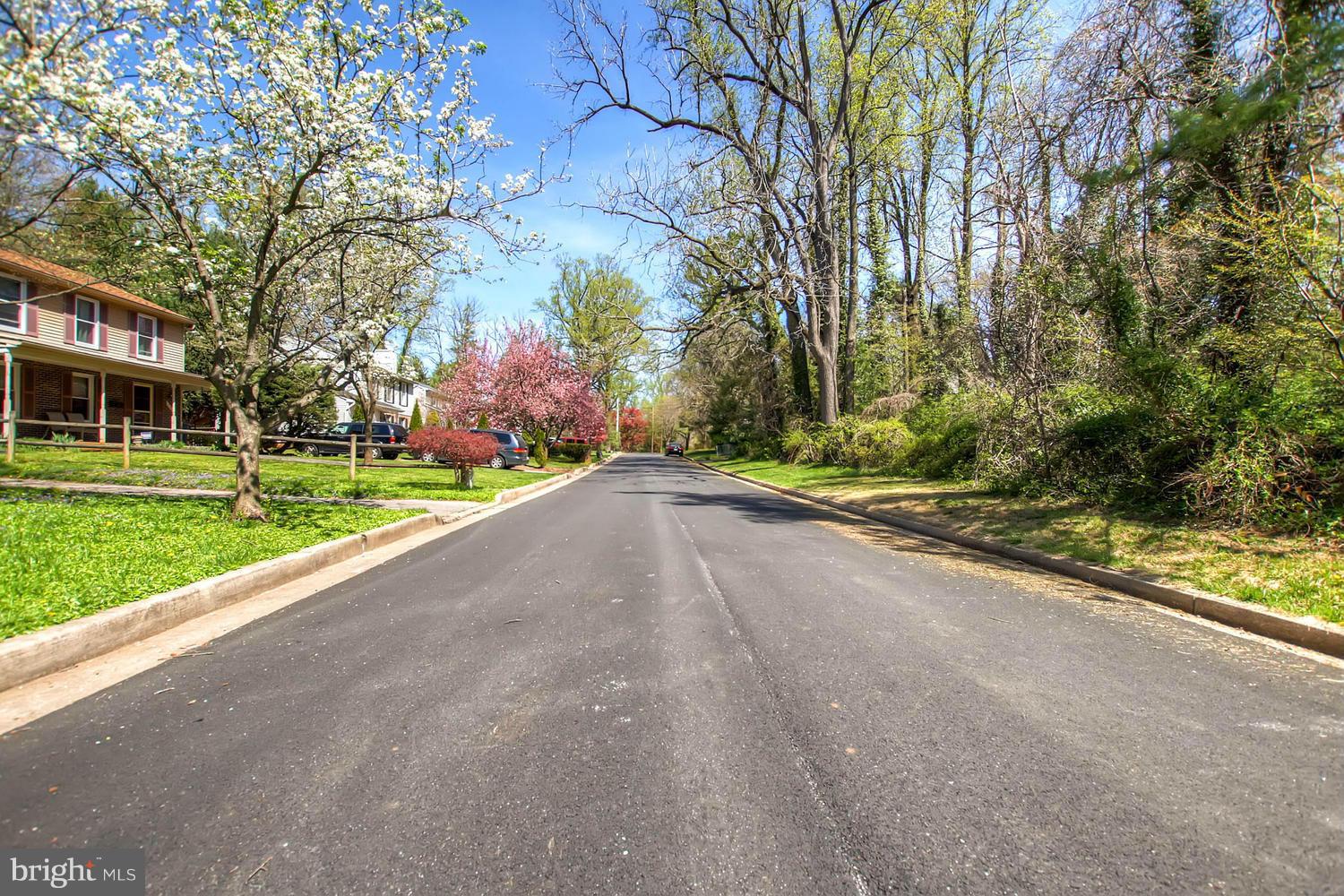 609 Cylburn Road Baltimore, MD 21208 - Photo 25 of 30 a view of a street with a building and trees in the background