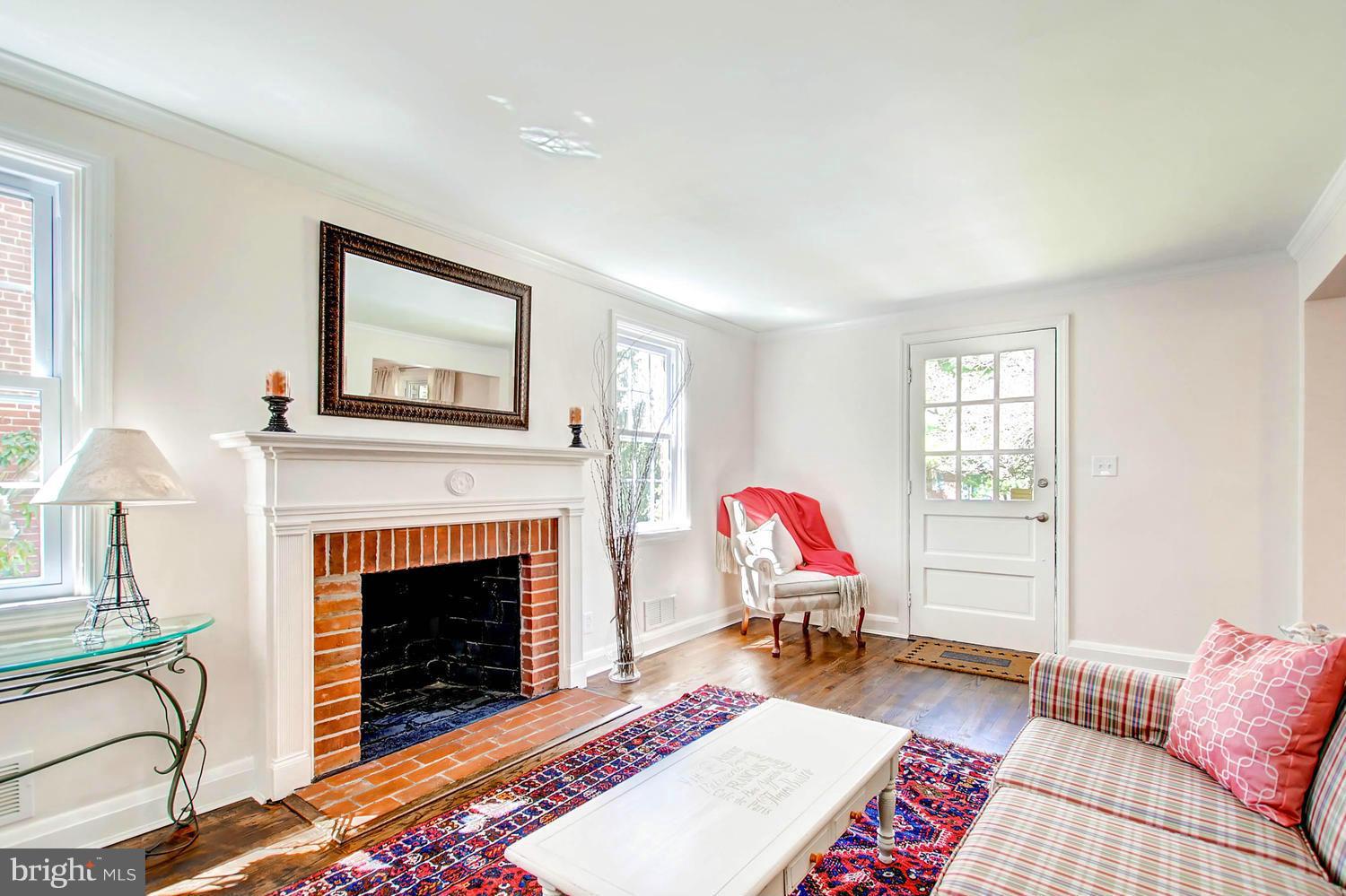 609 Cylburn Road Baltimore, MD 21208 - Photo 4 of 30 a living room with furniture a rug and a fireplace