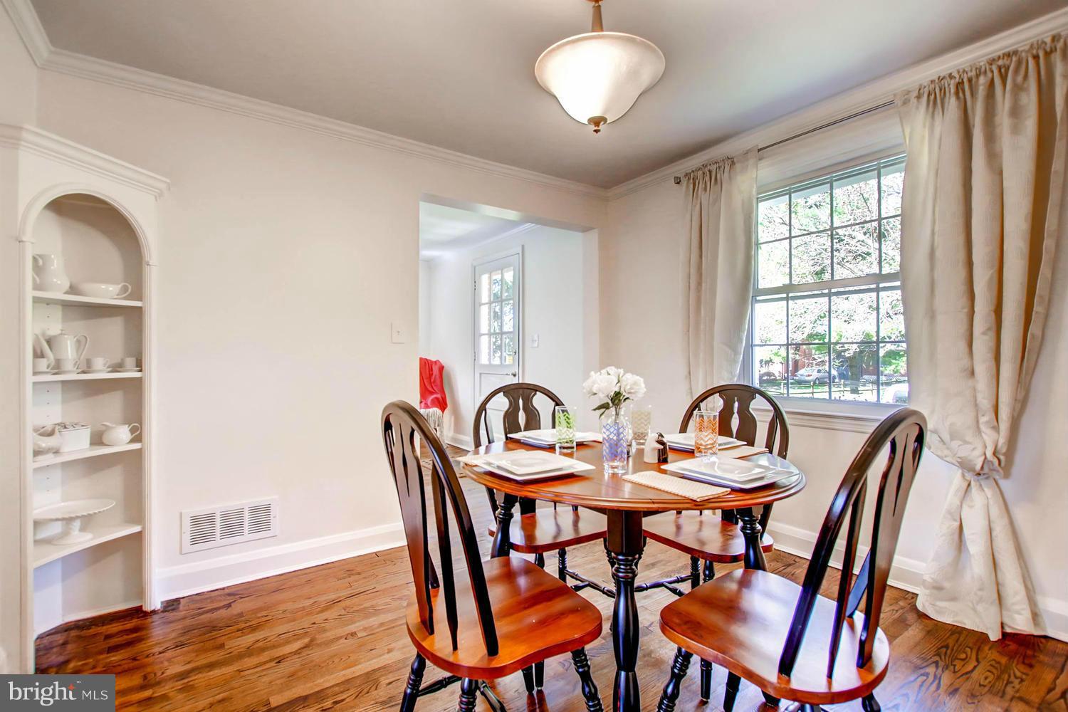 609 Cylburn Road Baltimore, MD 21208 - Photo 5 of 30 a view of a dining room with furniture window and wooden floor