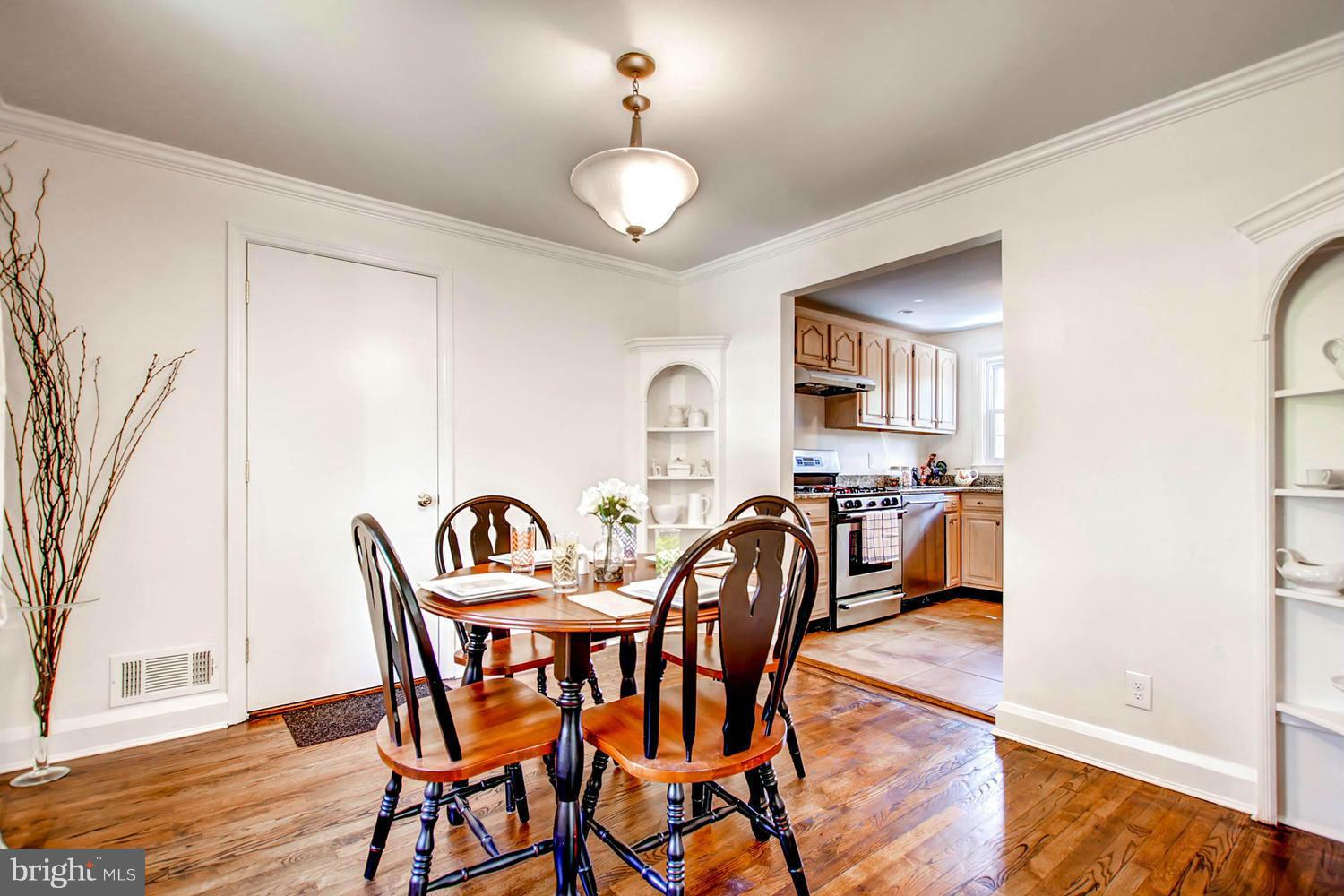 609 Cylburn Road Baltimore, MD 21208 - Photo 6 of 30 a view of a a dining room with furniture window and wooden floor