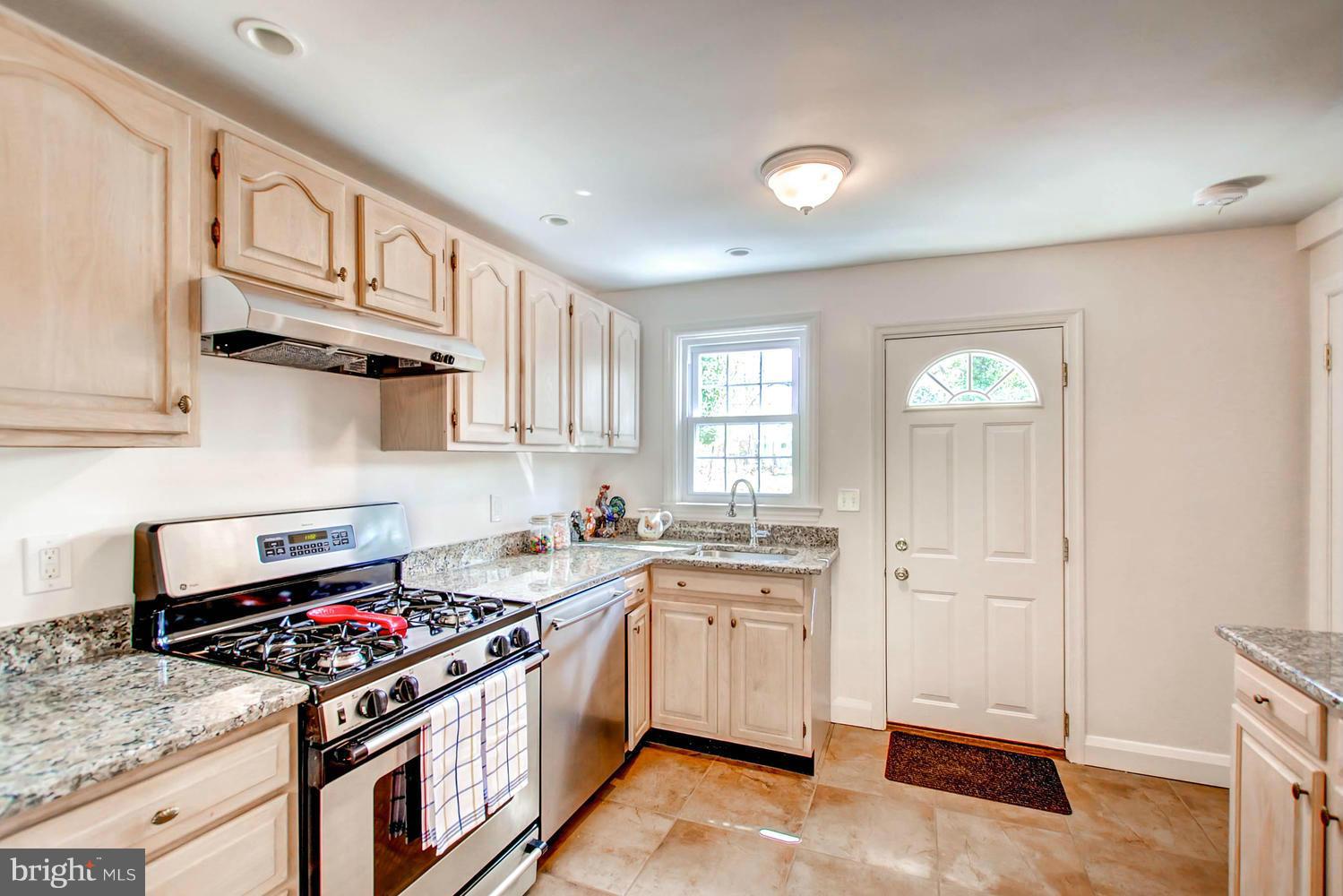 609 Cylburn Road Baltimore, MD 21208 - Photo 7 of 30 a kitchen with a stove a sink and a refrigerator