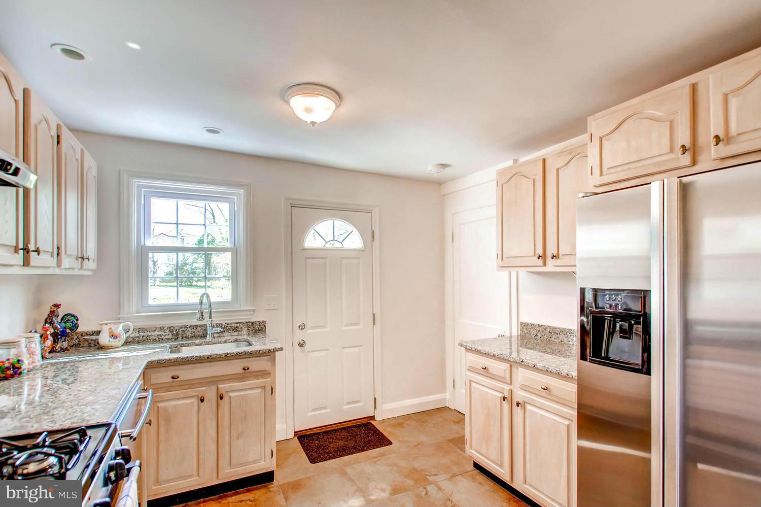 609 Cylburn Road Baltimore, MD 21208 - Photo 8 of 30 a kitchen with granite countertop a refrigerator stove and sink