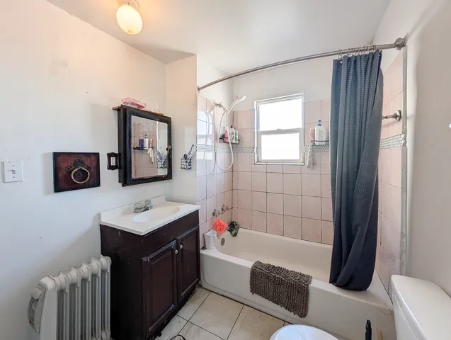 a bathroom with a tub a sink and a mirror