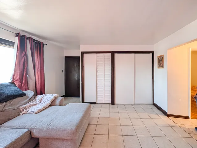 a view of a bedroom with a bed and a window