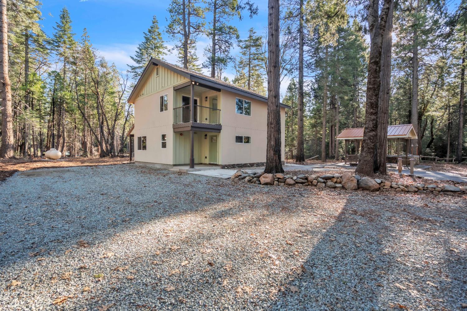 740 Hideaway Loop Alta, CA 95701 - Photo 2 of 74 a view of a white house with a yard and large trees