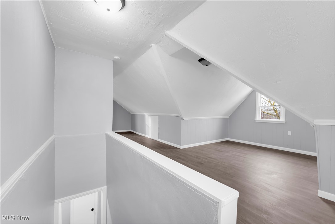953 Whitby Road Cleveland Heights, OH 44112 - Photo 16 of 27 Additional living space with dark wood-style floors and lofted ceiling