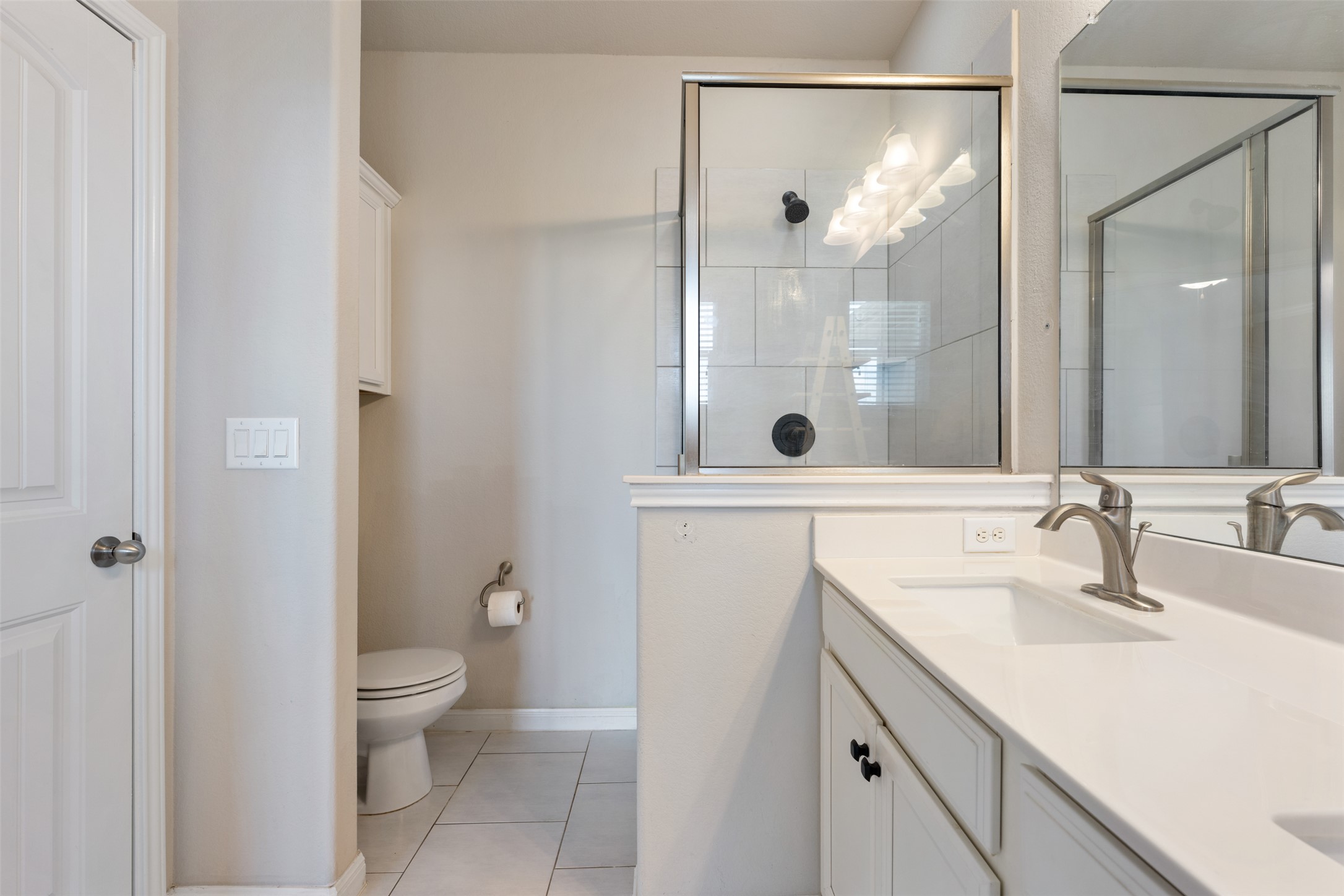 211 Parable Cove Pflugerville, TX 78660 - Photo 27 of 40 White vanity with a solid surface countertop and undermount sink