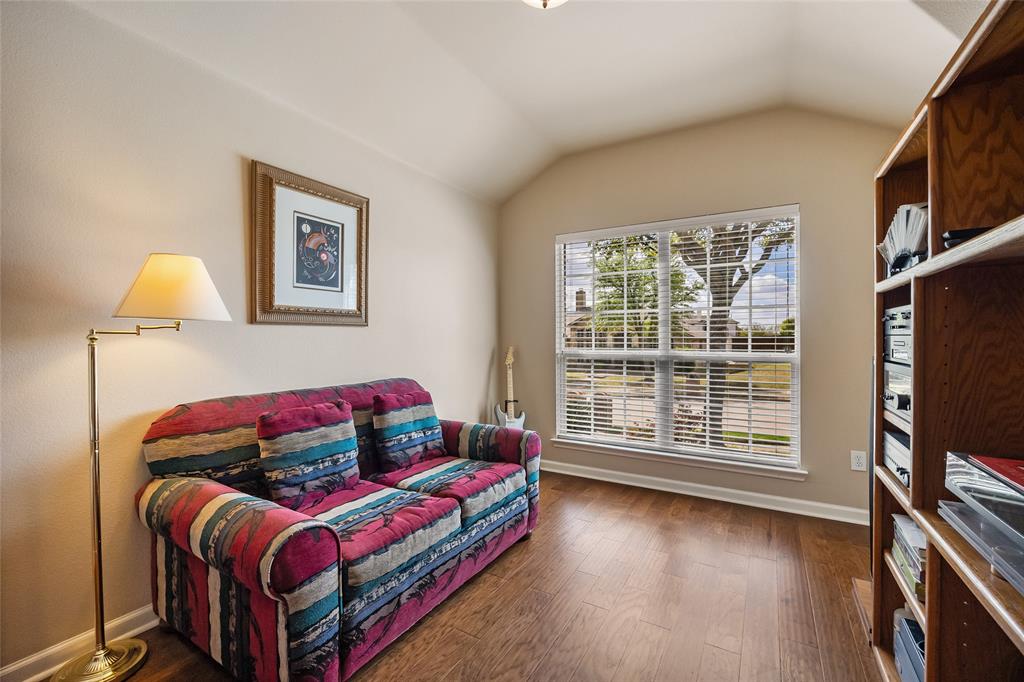 1260 Highbluff Lane Rockwall, TX 75087 - Photo 12 of 22 a bedroom with a bed and a flat screen tv
