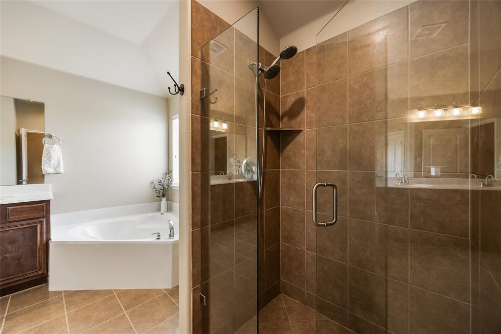 1260 Highbluff Lane Rockwall, TX 75087 - Photo 16 of 22 a bathroom with a bathtub and a shower