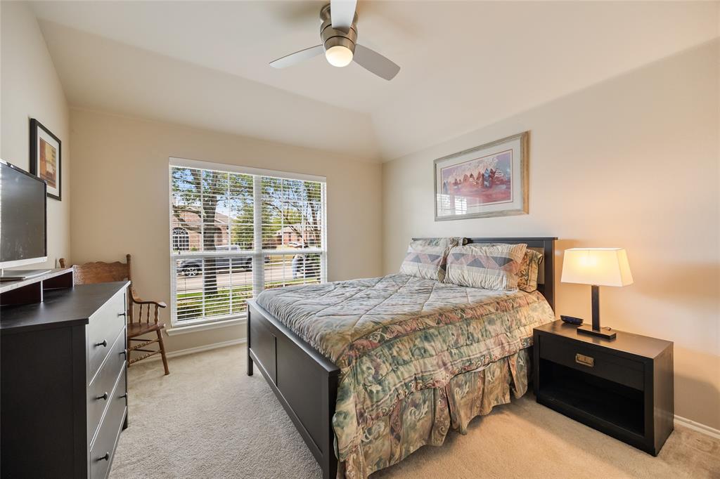 1260 Highbluff Lane Rockwall, TX 75087 - Photo 18 of 22 a bed room with a bed window and a flat tv screen on a dresser