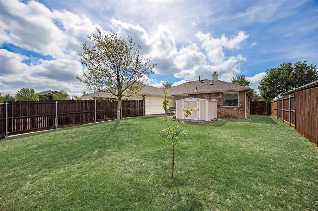 1260 Highbluff Lane Rockwall, TX 75087 - Photo 22 of 22 a view of a house with backyard and porch