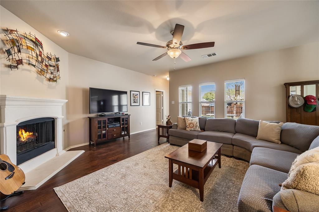1260 Highbluff Lane Rockwall, TX 75087 - Photo 5 of 22 a living room with furniture a fireplace and a flat screen tv