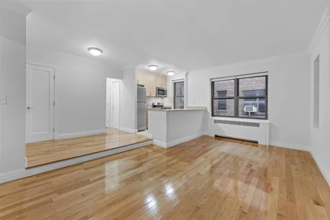 a view of livingroom with hardwood floor and cabinet
