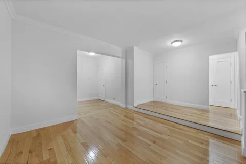 a view of an empty room and wooden floor