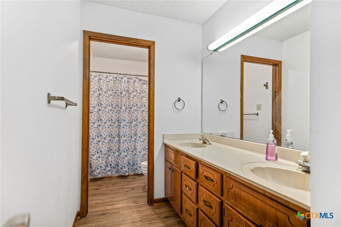 181 Pecan Street Port Lavaca, TX 77979 - Photo 22 of 34 a bathroom with a sink a mirror and a shower