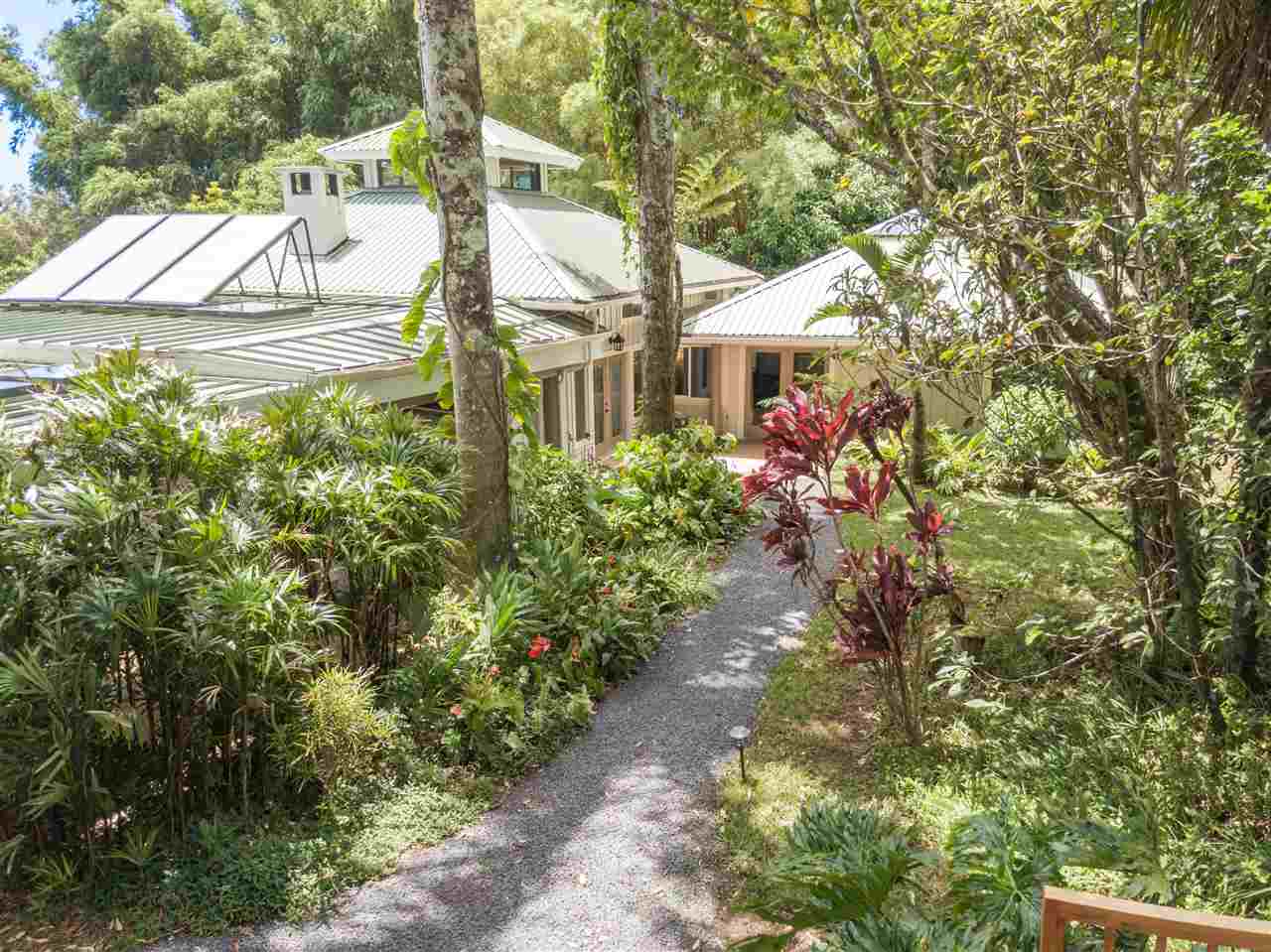 a view of a house with a yard and garden