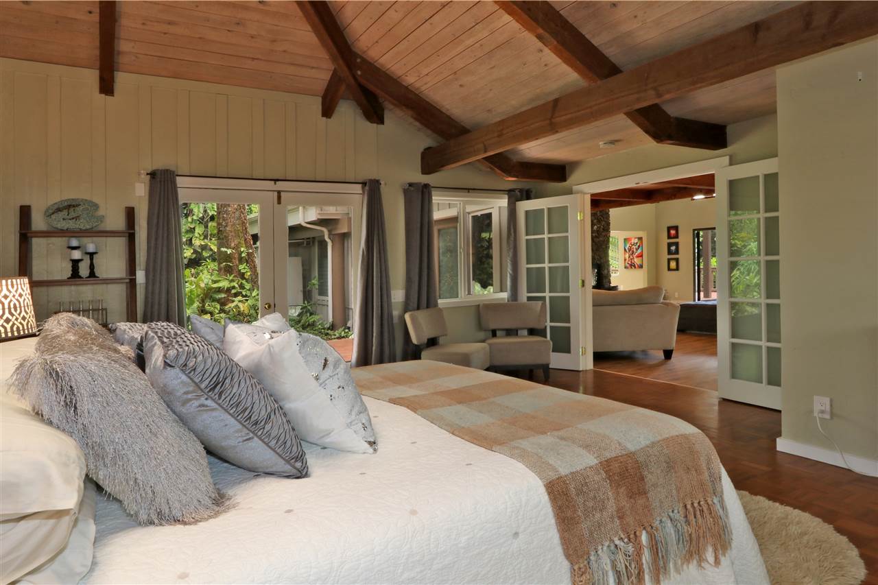 620 Awalau Road Haiku, HI 96708 - Photo 11 of 30 a bedroom with a large bed and a large window