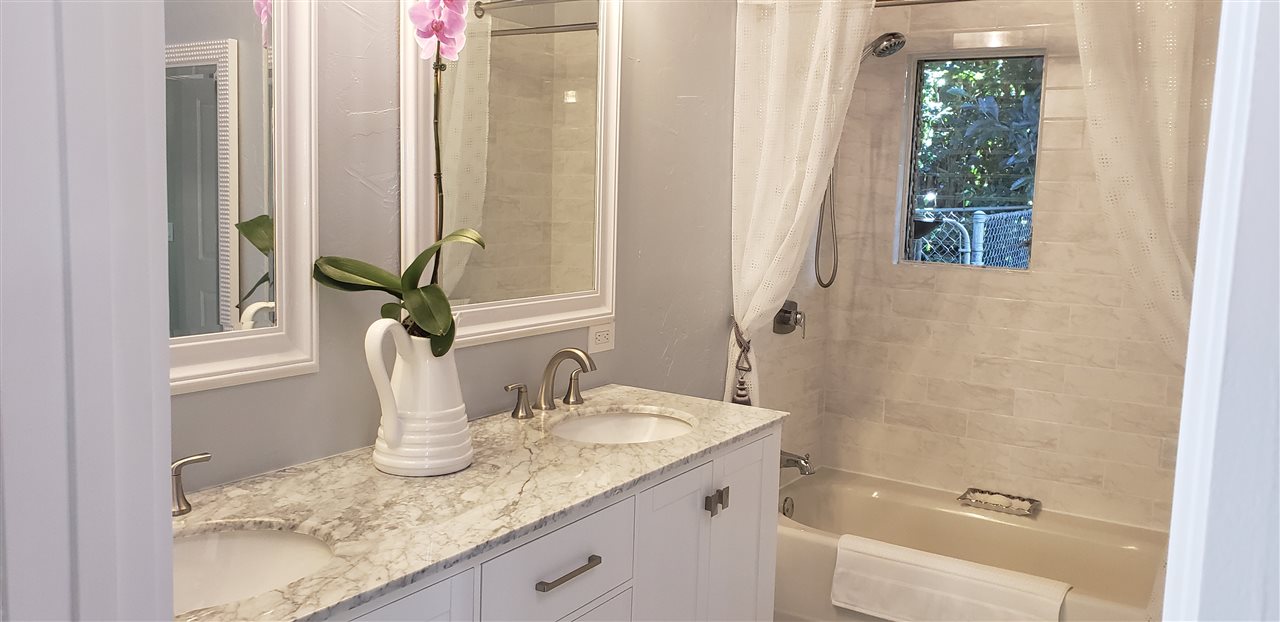 620 Awalau Road Haiku, HI 96708 - Photo 12 of 30 a bathroom with a granite countertop sink and a mirror
