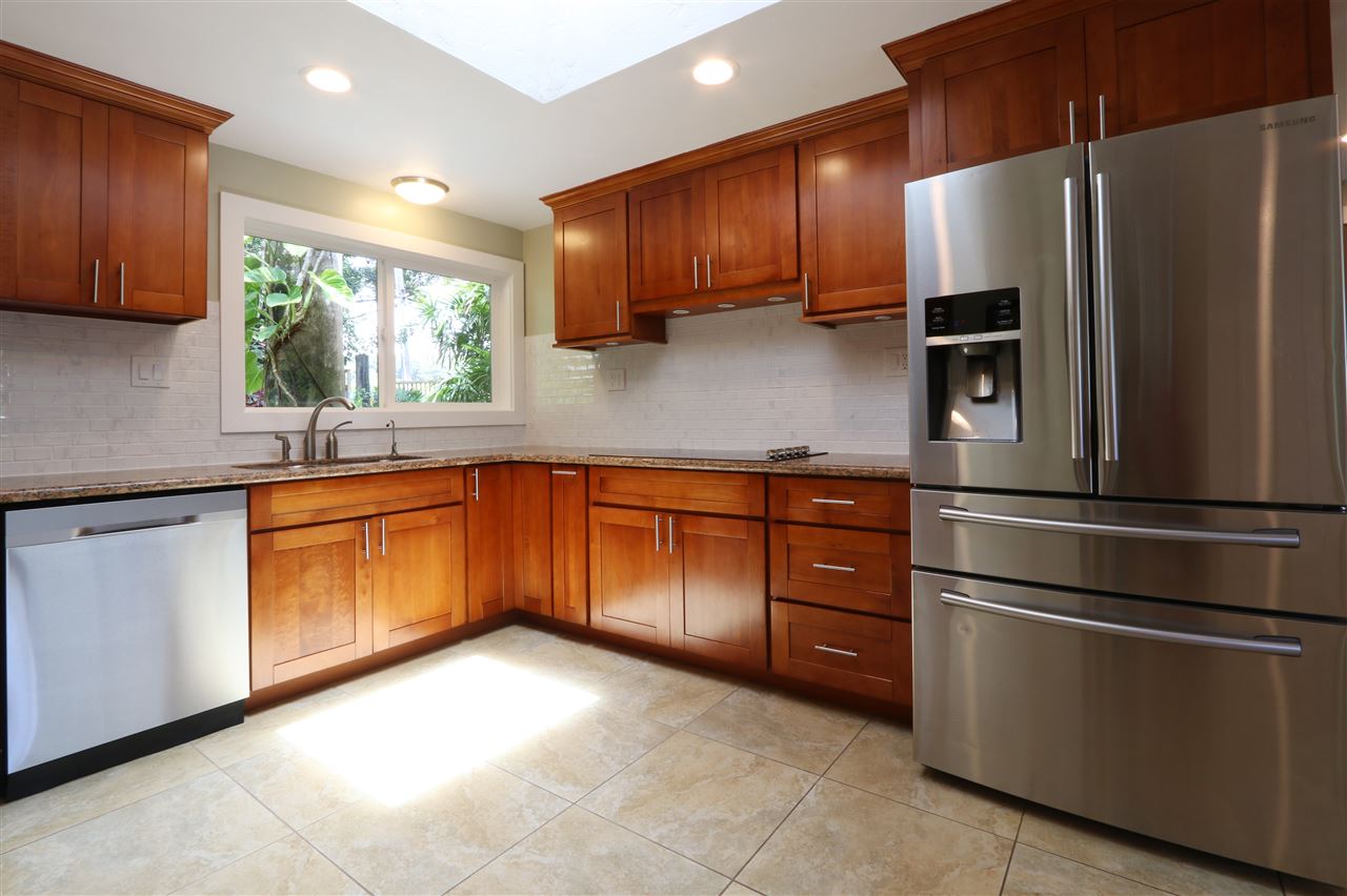 620 Awalau Road Haiku, HI 96708 - Photo 14 of 30 a kitchen with stainless steel appliances granite countertop a refrigerator and a sink