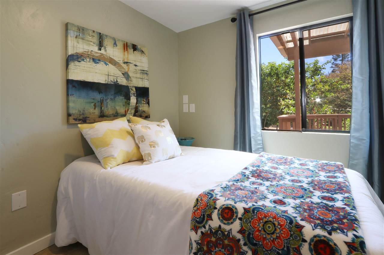 620 Awalau Road Haiku, HI 96708 - Photo 17 of 30 a bedroom with a large bed and a window