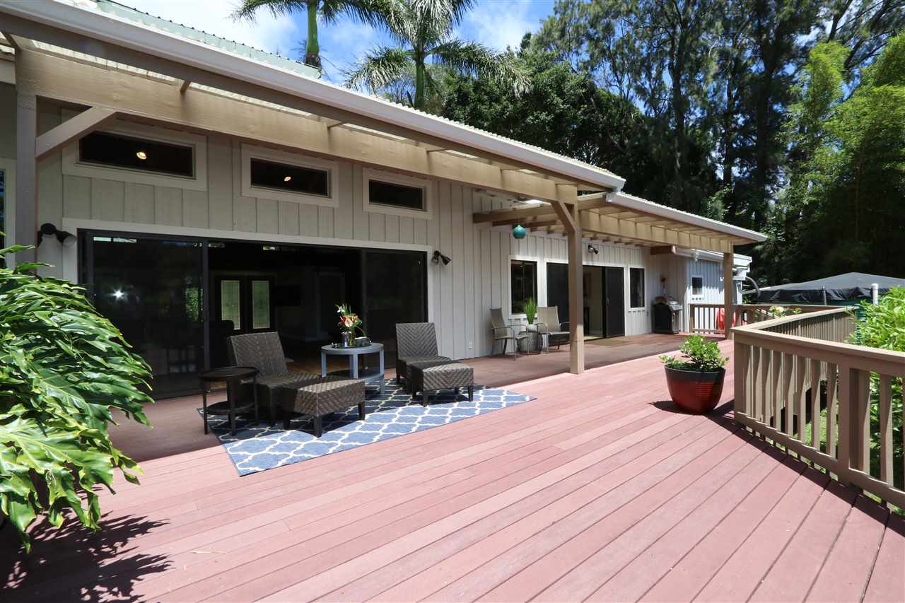 620 Awalau Road Haiku, HI 96708 - Photo 20 of 30 a view of a patio with table and chairs and wooden floor