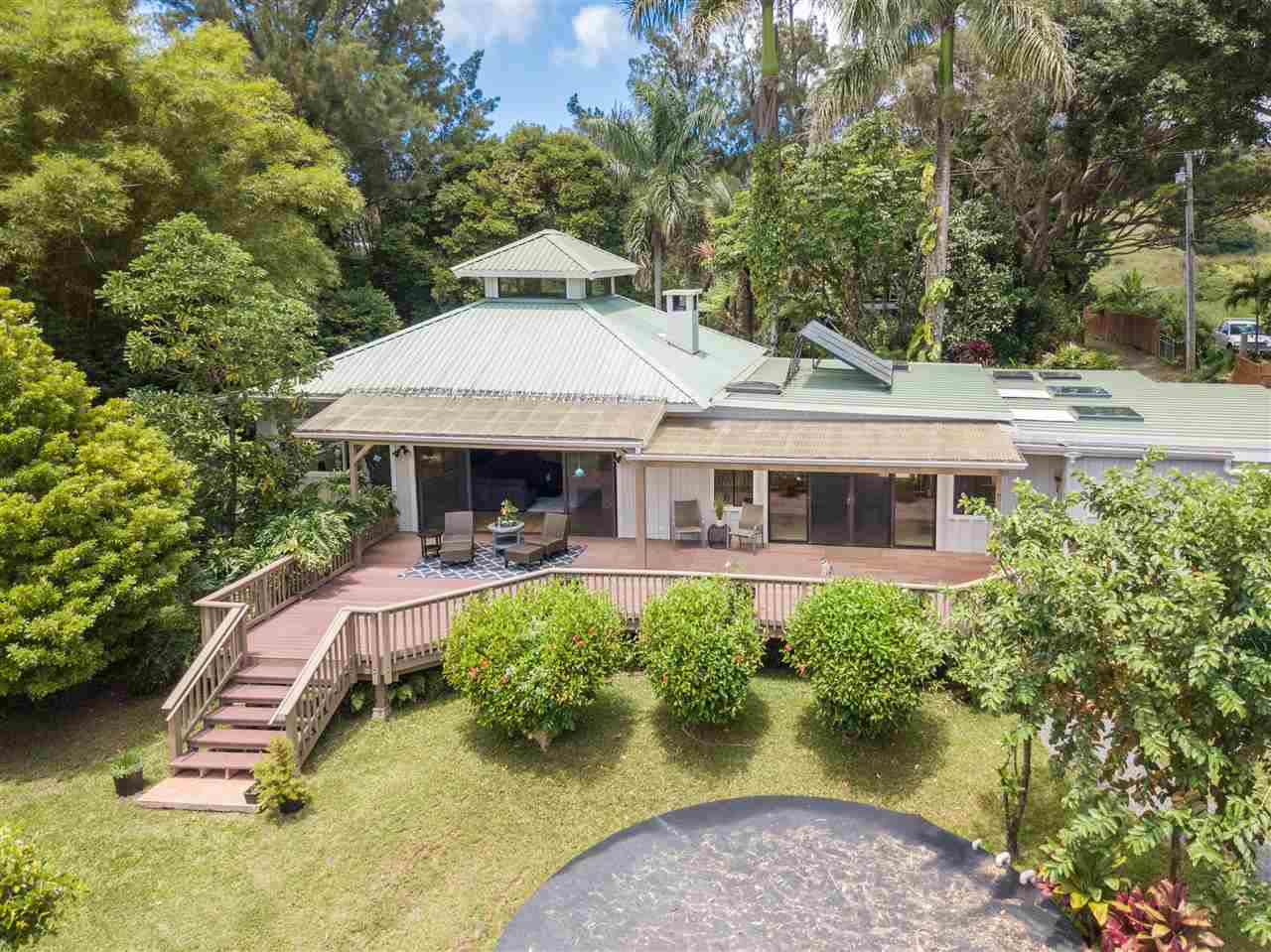 620 Awalau Road Haiku, HI 96708 - Photo 2 of 30 a front view of a house with swimming pool and porch