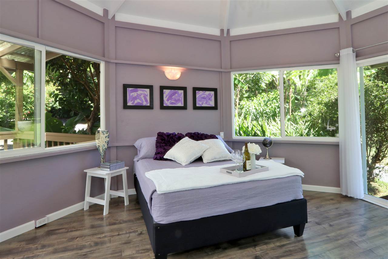 620 Awalau Road Haiku, HI 96708 - Photo 24 of 30 a bedroom with a bed and a large window