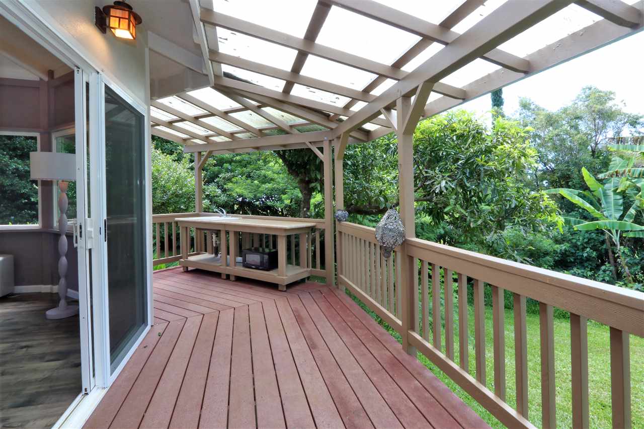 620 Awalau Road Haiku, HI 96708 - Photo 26 of 30 a view of a balcony with chairs and wooden floor