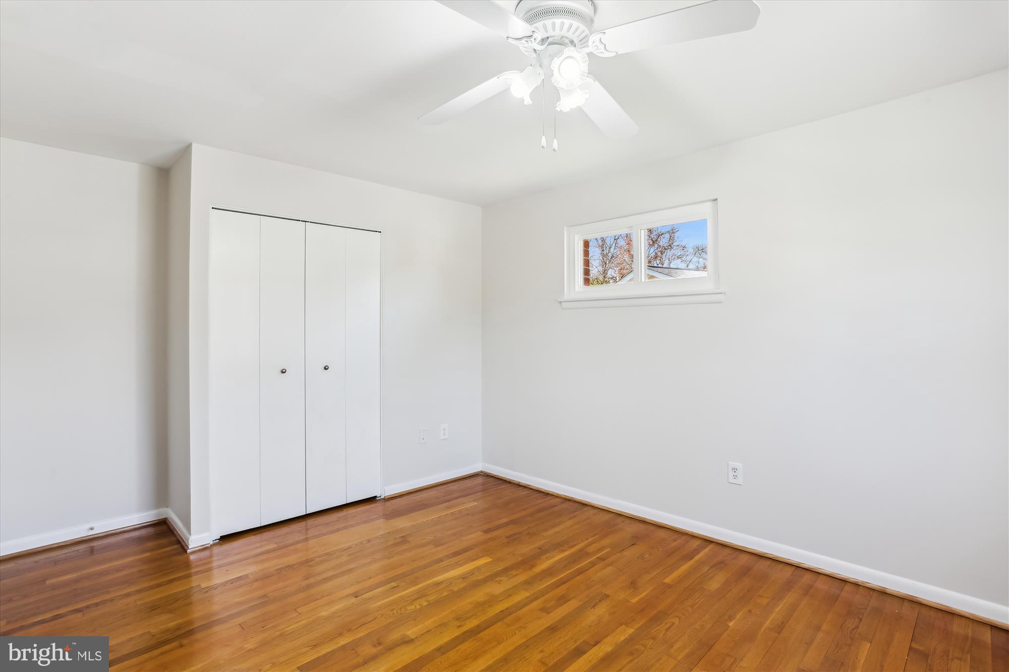 9 Fulham Court Silver Spring, MD 20902 - Photo 27 of 53 an empty room with wooden floor and fan