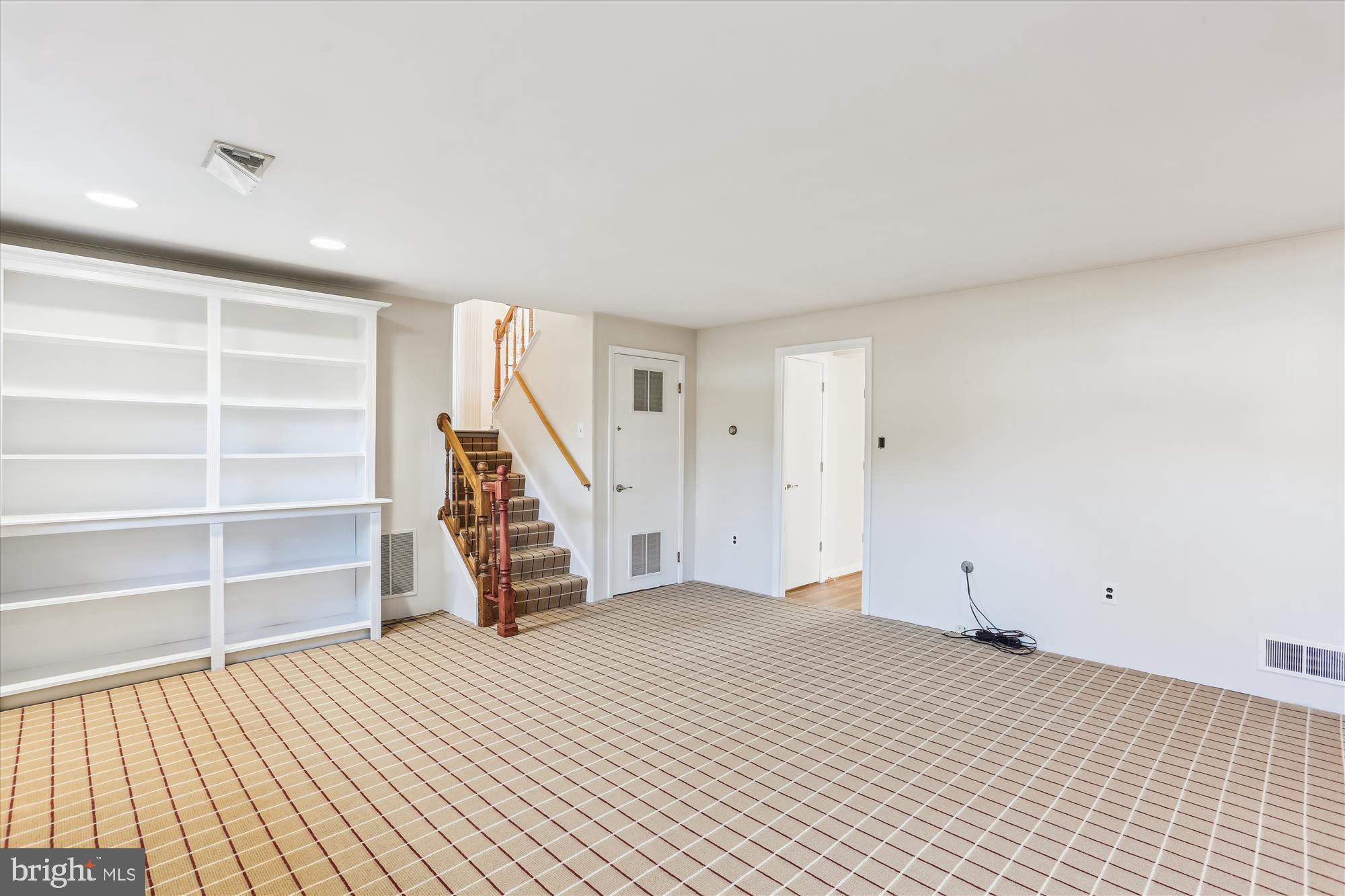 9 Fulham Court Silver Spring, MD 20902 - Photo 33 of 53 a view of an empty room with wooden floor and stairs