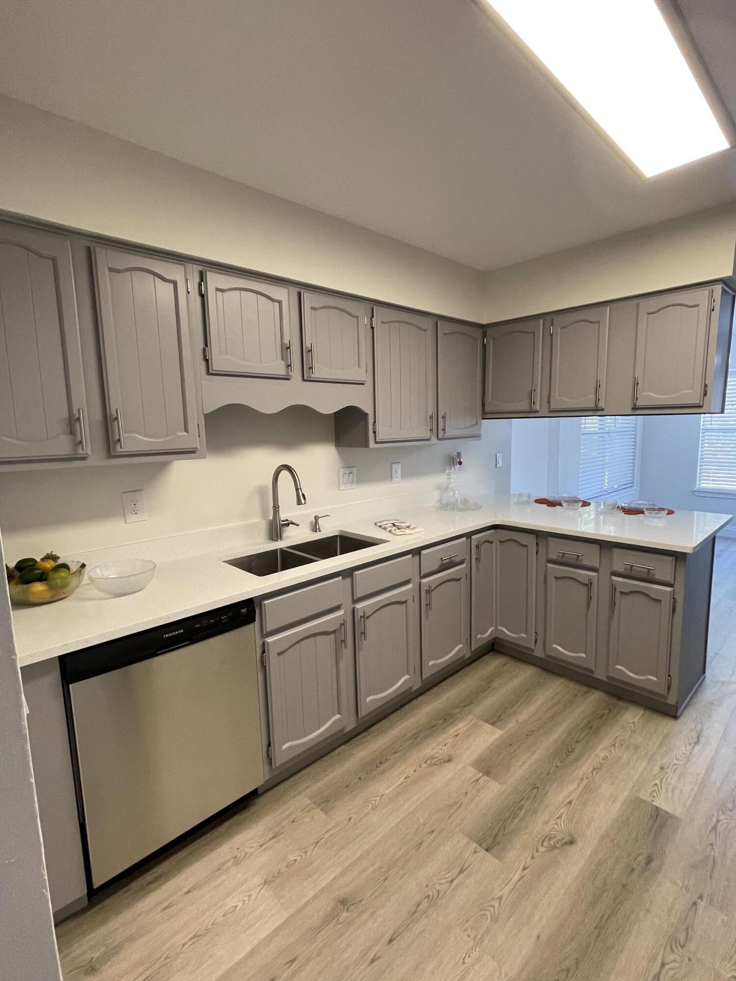 433 Barbados Way Niceville, FL 32578 - Photo 12 of 65 a kitchen with granite countertop a sink cabinets and stainless steel appliances