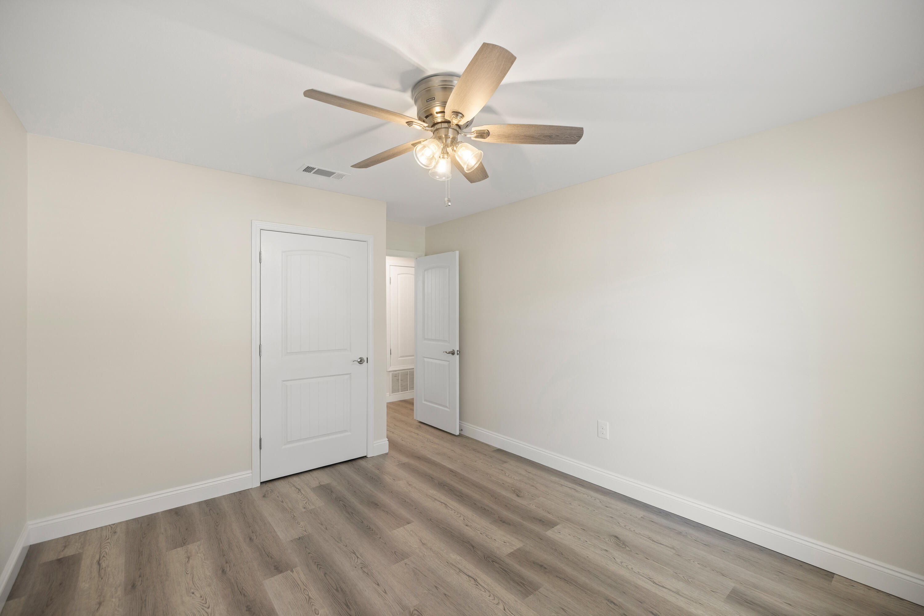 433 Barbados Way Niceville, FL 32578 - Photo 27 of 65 a view of an empty room with wooden floor