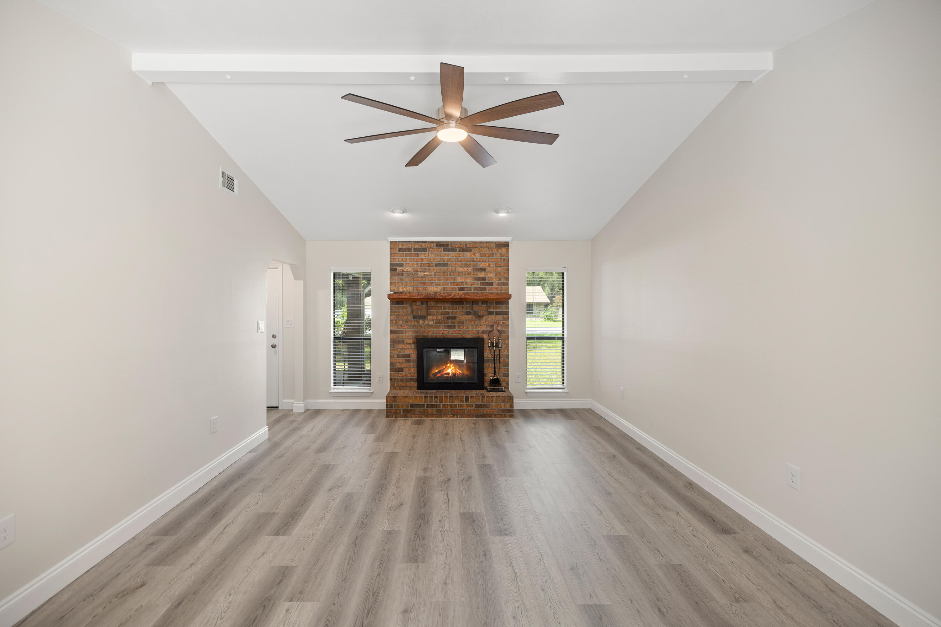 433 Barbados Way Niceville, FL 32578 - Photo 6 of 65 a view of empty room with wooden floor and fireplace