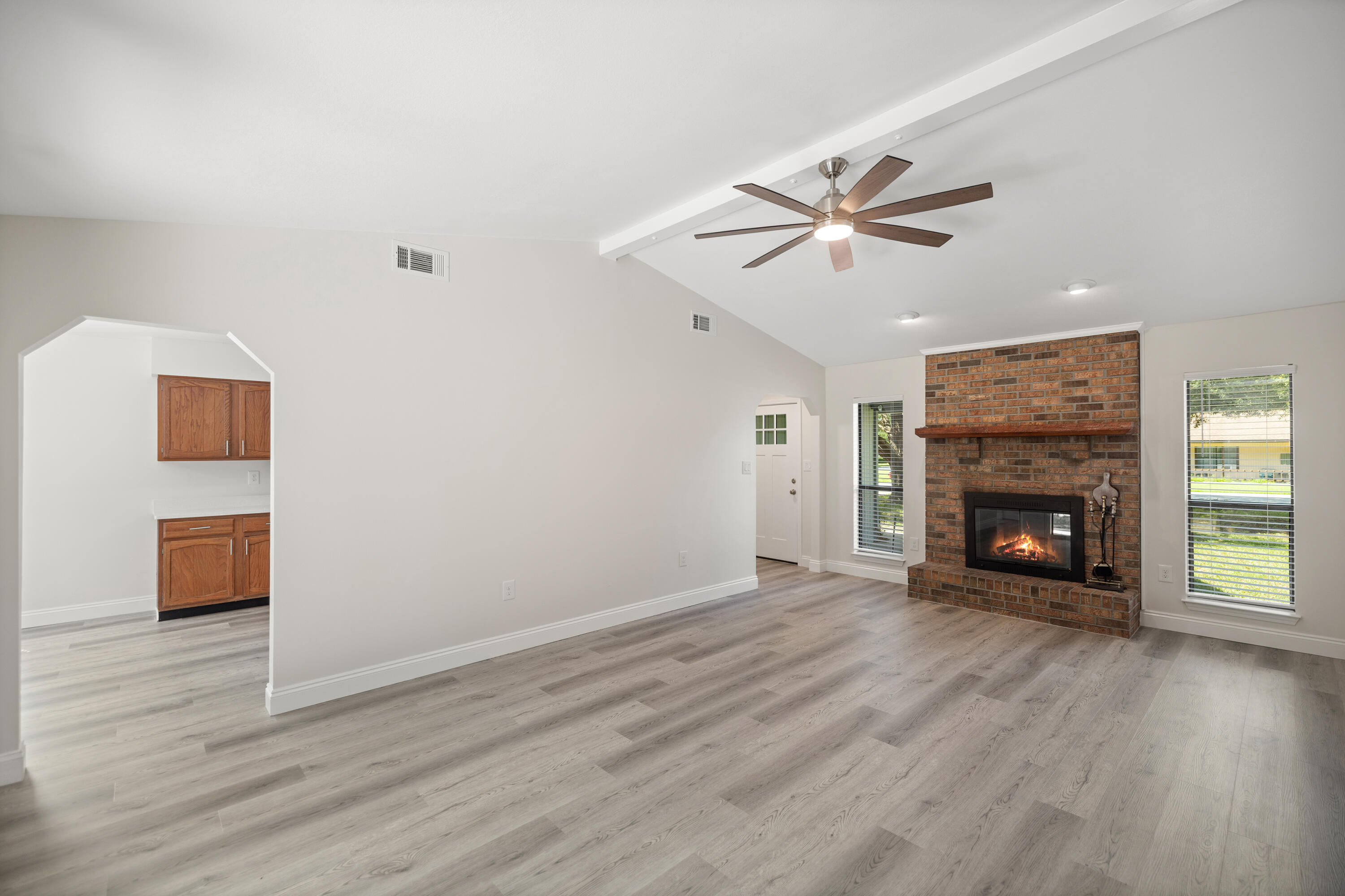 433 Barbados Way Niceville, FL 32578 - Photo 8 of 65 an empty room with wooden floor a fire place and a fireplace