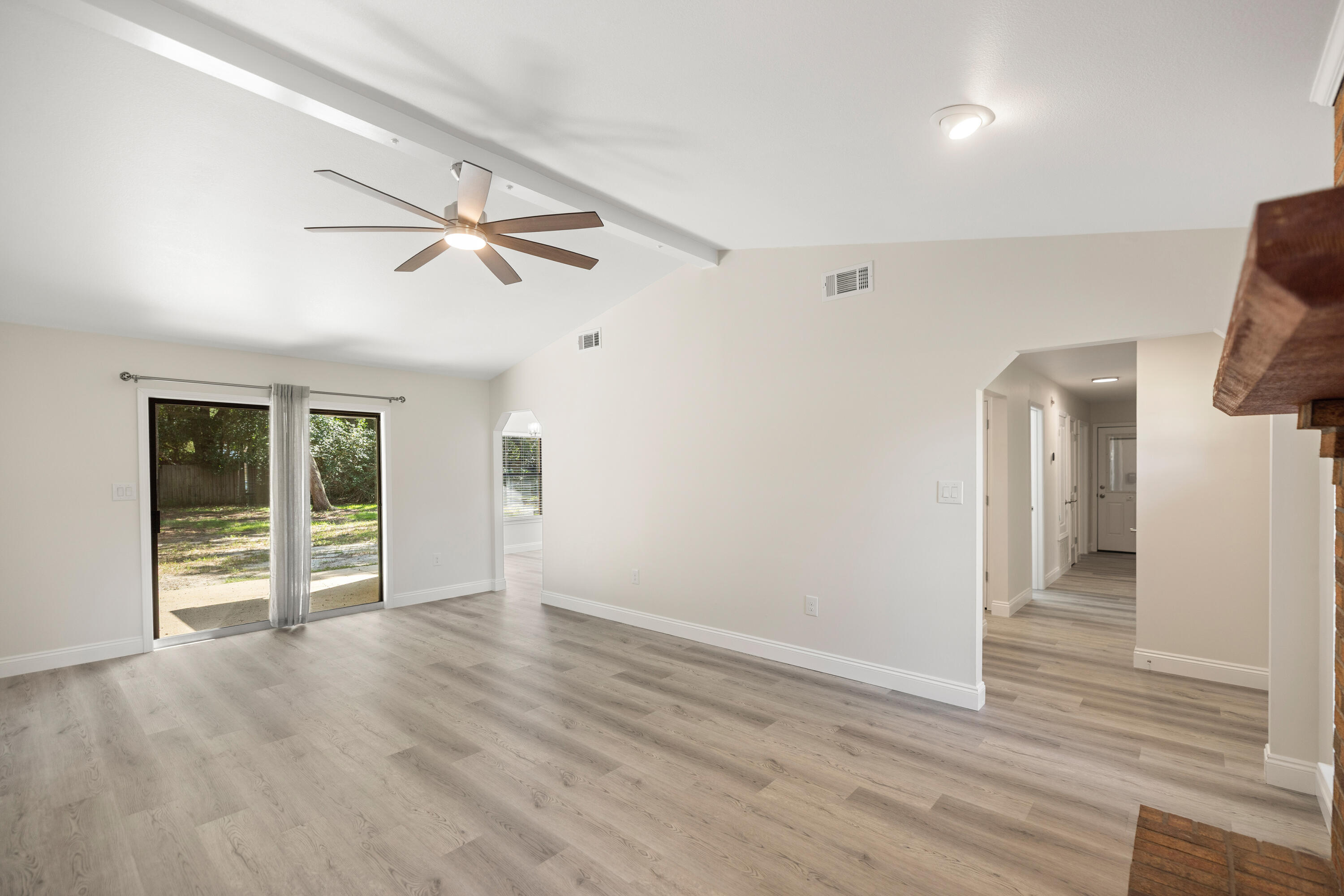 433 Barbados Way Niceville, FL 32578 - Photo 9 of 65 wooden floor in an empty room with a window