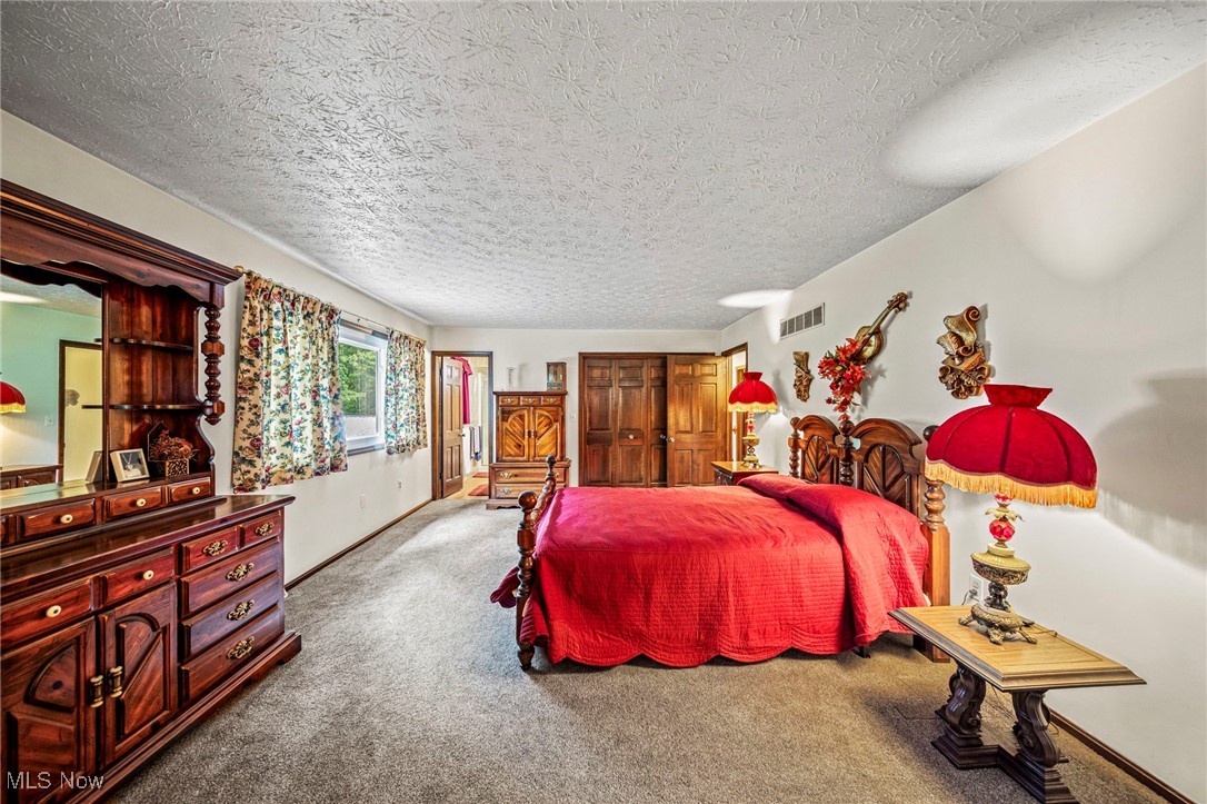 2921 Sexton Road Geneva, OH 44041 - Photo 42 of 43 Carpeted bedroom featuring a textured ceiling and baseboards