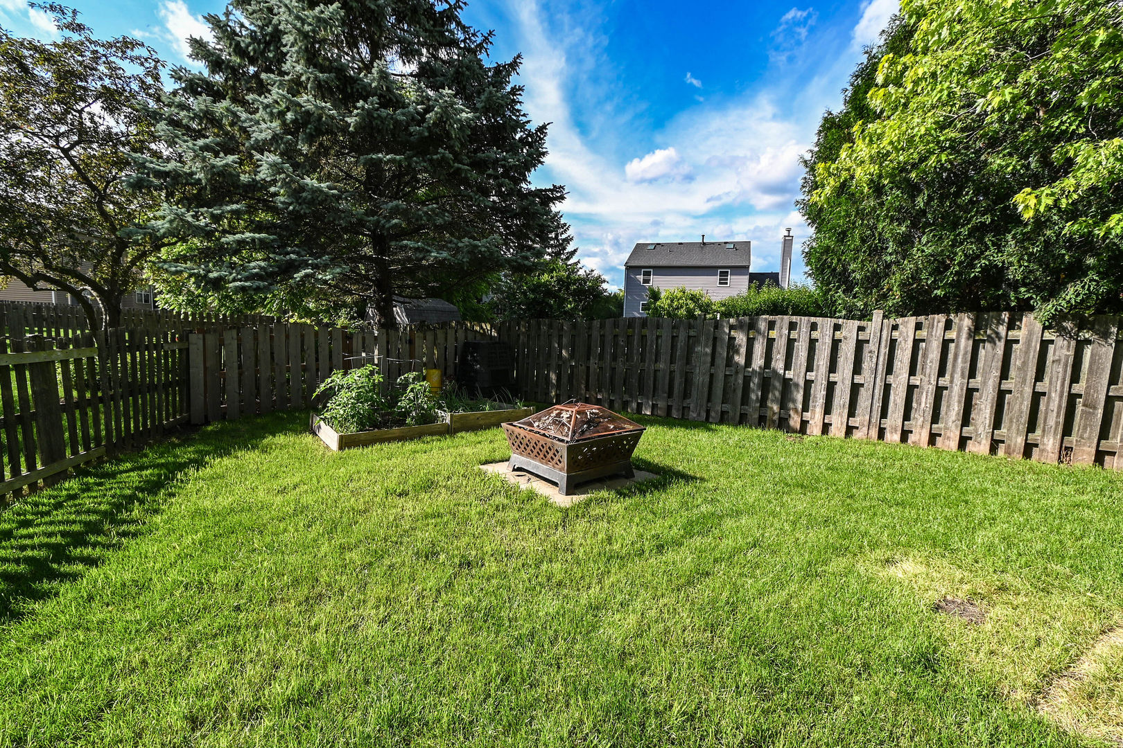 1333 Regency Lane Round Lake, IL 60073 - Photo 29 of 31 a view of a backyard with a garden and deck
