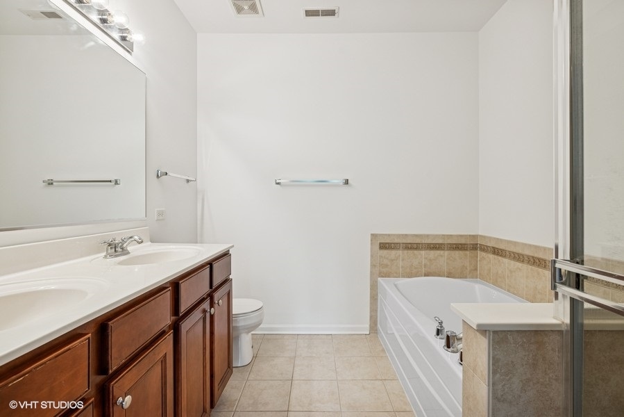 1541 Millbrook Drive, Unit 1541 Algonquin, IL 60102 - Photo 12 of 17 a bathroom with a sink and a mirror