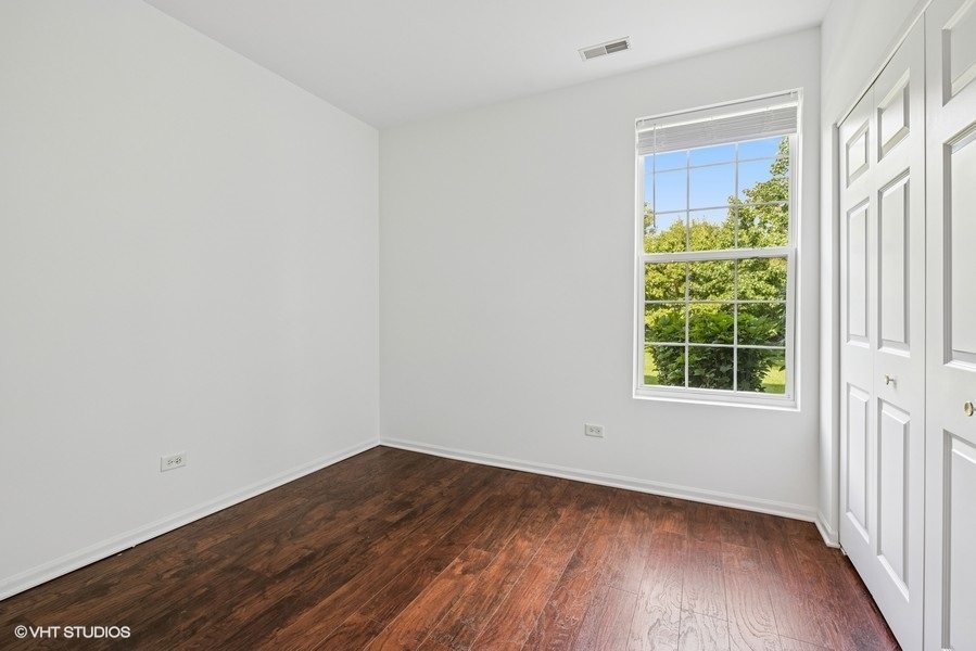 1541 Millbrook Drive, Unit 1541 Algonquin, IL 60102 - Photo 14 of 17 a view of a room that has wooden floor and a window