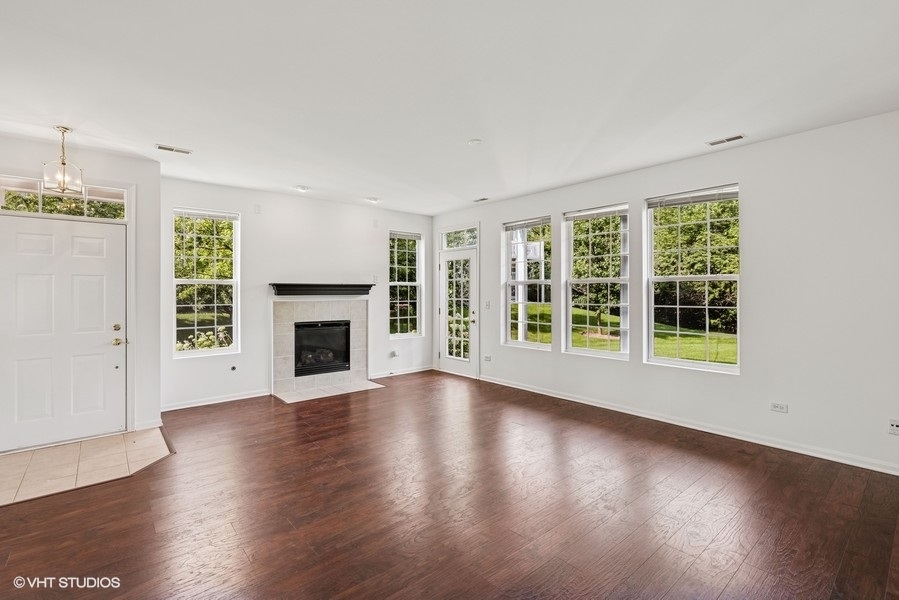 1541 Millbrook Drive, Unit 1541 Algonquin, IL 60102 - Photo 4 of 17 a view of an empty room with wooden floor and a window