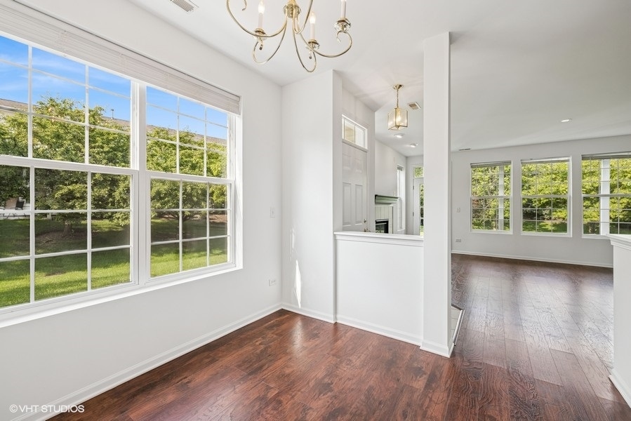 1541 Millbrook Drive, Unit 1541 Algonquin, IL 60102 - Photo 7 of 17 a view of an empty room with wooden floor and a window