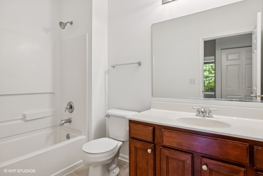 1541 Millbrook Drive, Unit 1541 Algonquin, IL 60102 - Photo 9 of 17 a bathroom with a sink a toilet and shower