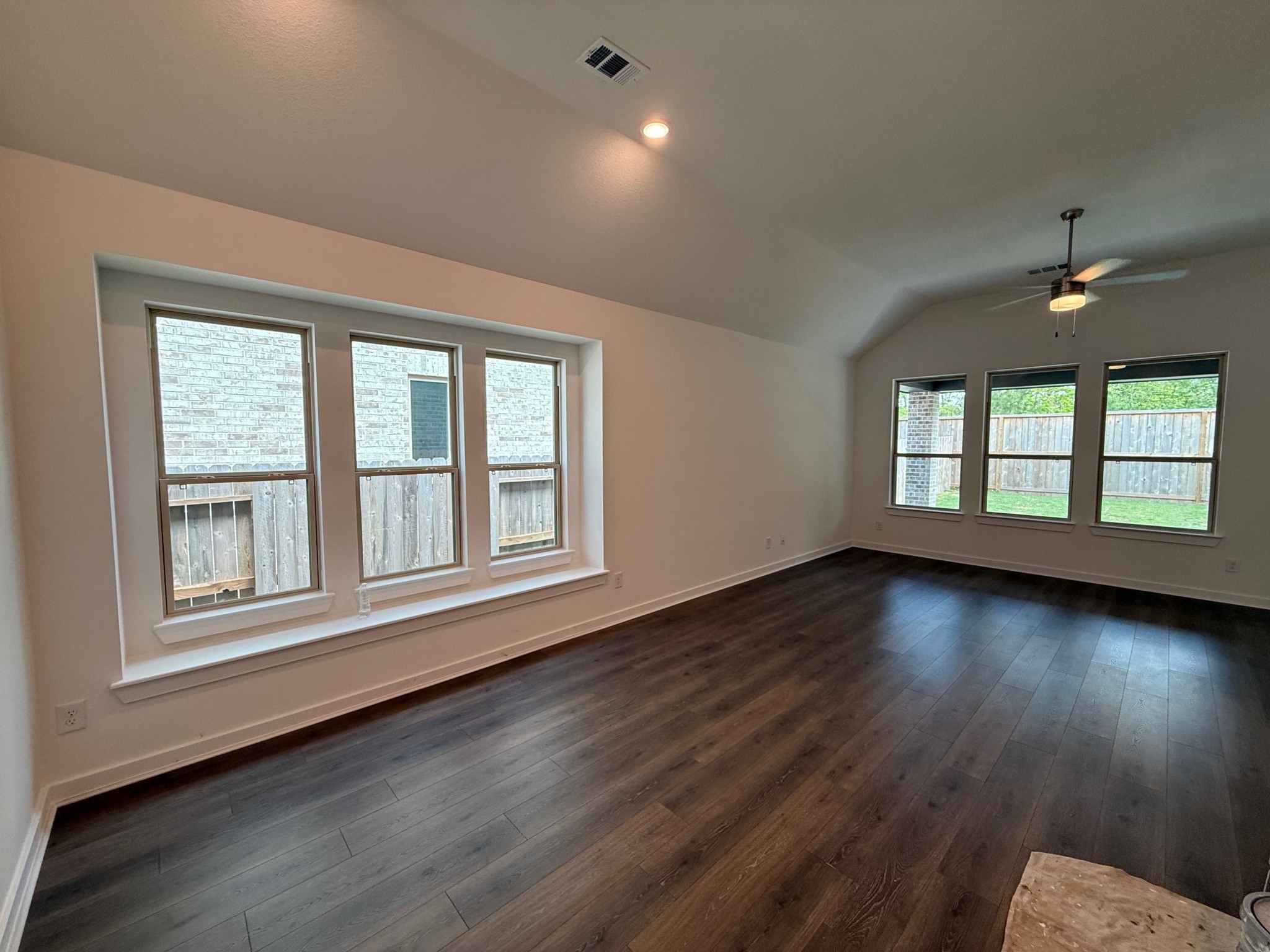 16383 Placid Strm Street Conroe, TX 77302 - Photo 4 of 15 a view of an empty room with wooden floor and a window