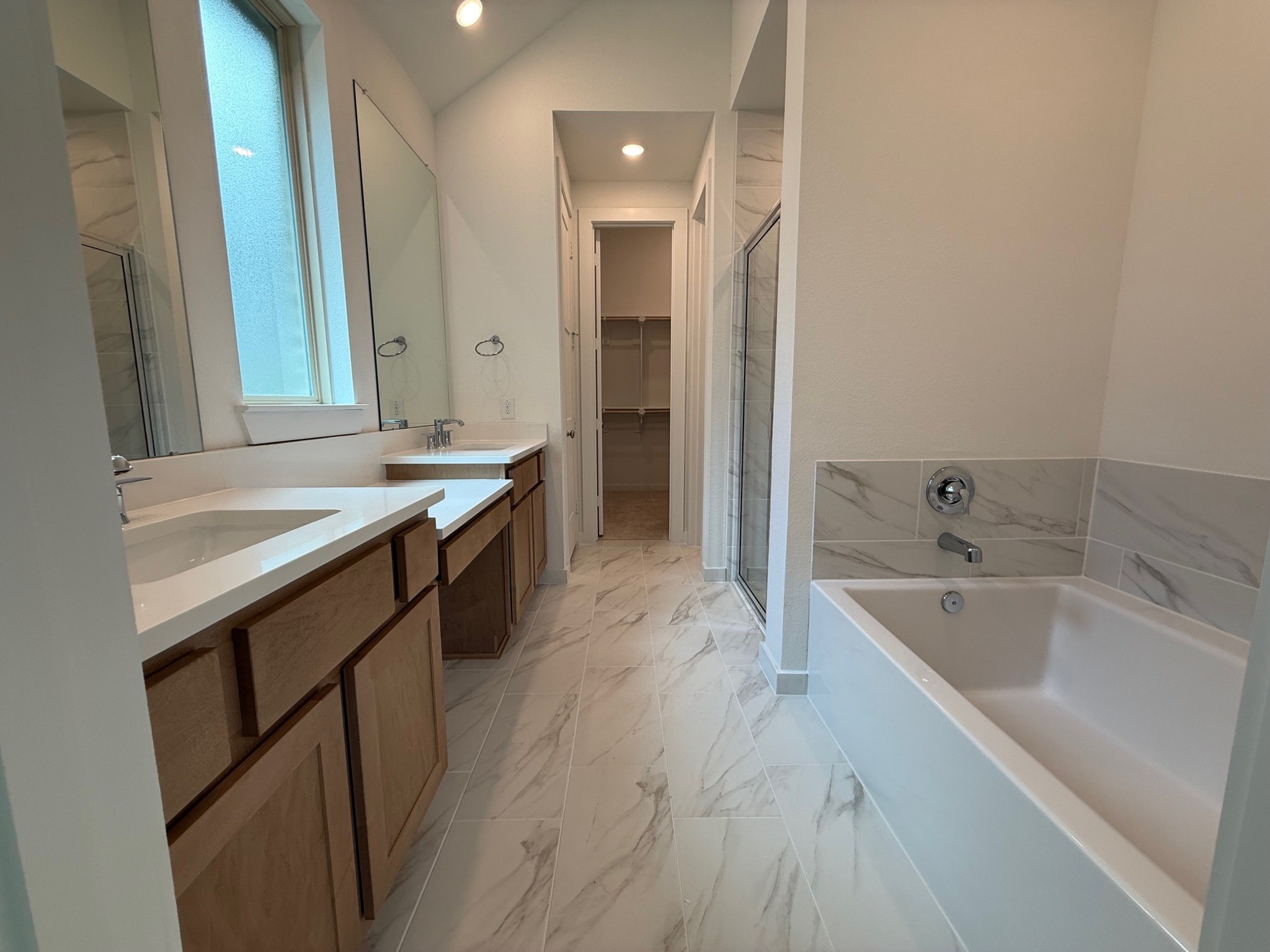 16383 Placid Strm Street Conroe, TX 77302 - Photo 6 of 15 a spacious bathroom with a bathtub sink and mirror