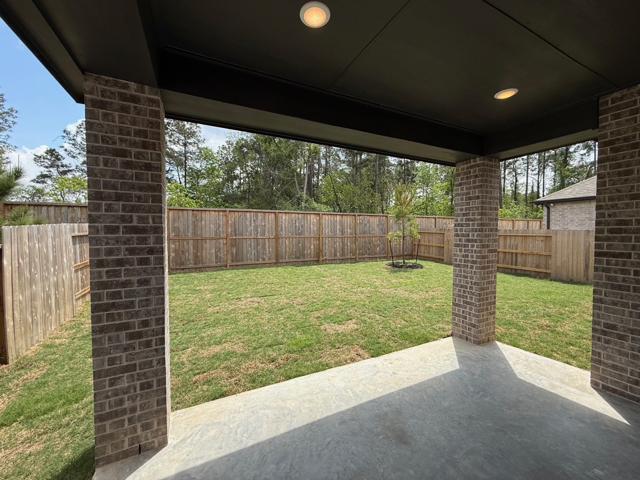 16383 Placid Strm Street Conroe, TX 77302 - Photo 7 of 15 a view of backyard with green space and porch area