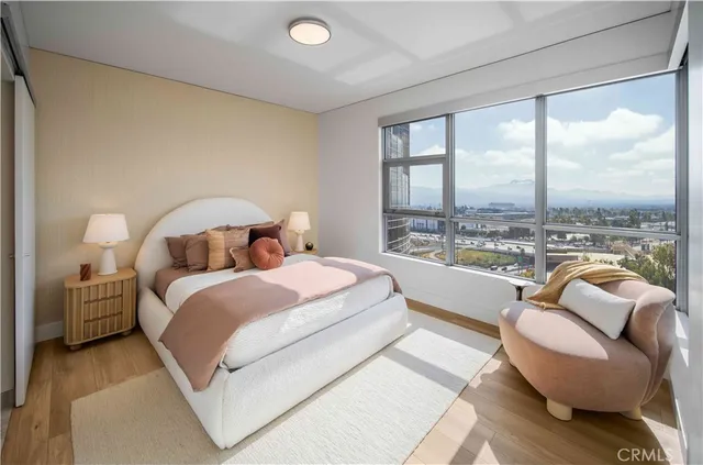 a bedroom with a bed and a large window