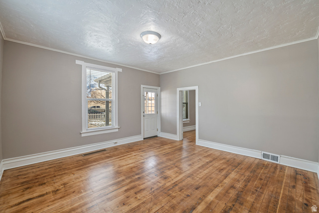 75 600 West Provo, UT 84601 - Photo 9 of 26 Spacious interior room featuring wood-finish flooring, neutral wall tones, and white trim