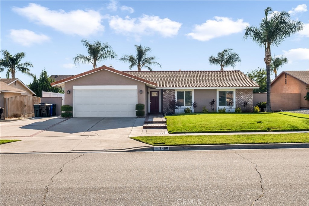 7468 Jacaranda Avenue Fontana, CA 92336 - Photo 1 of 1 a front view of a house with a garden and garage